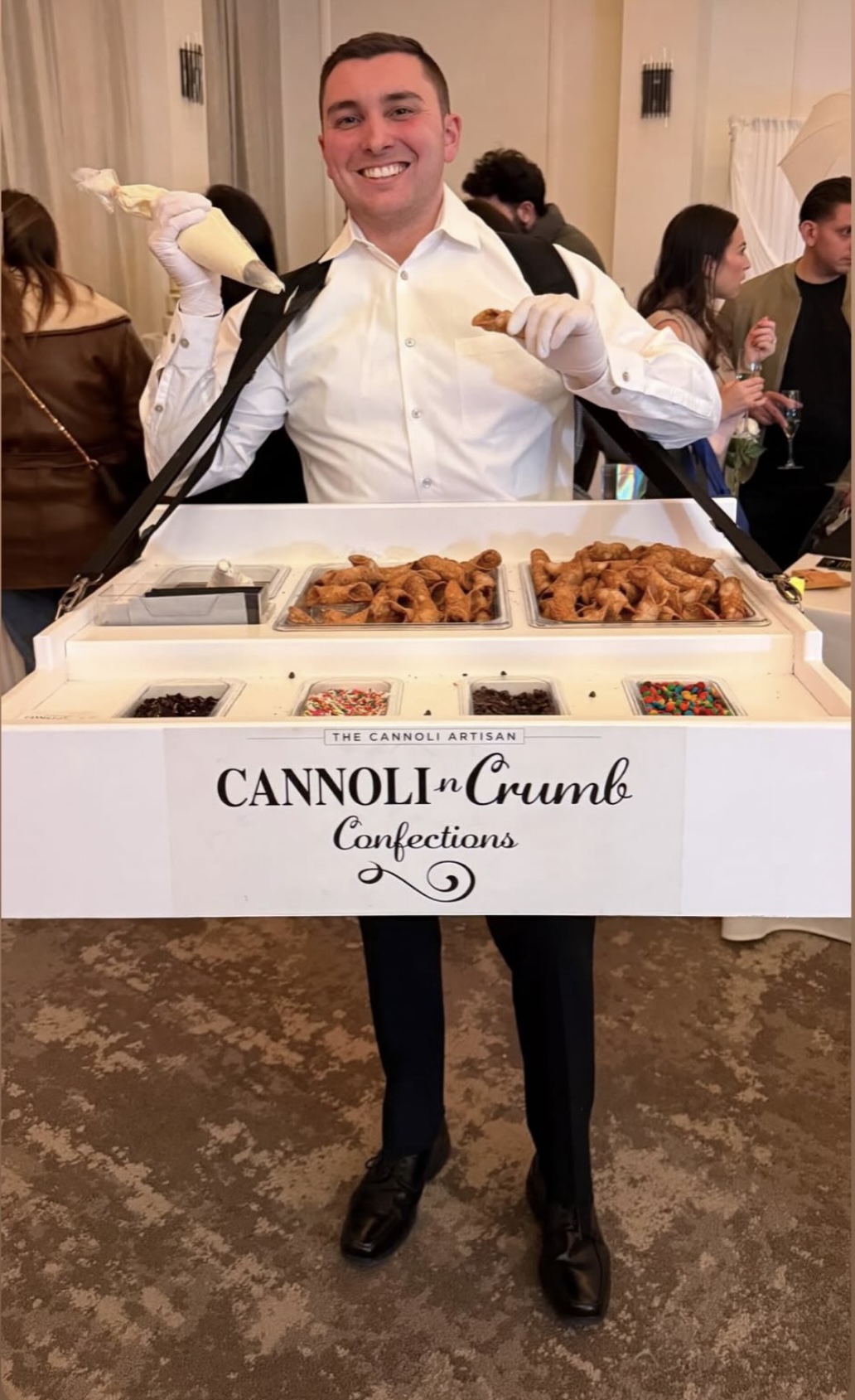 The strolling tray filled with cannoli alongside bowls of chocolate chips, sprinkles and candy toppings